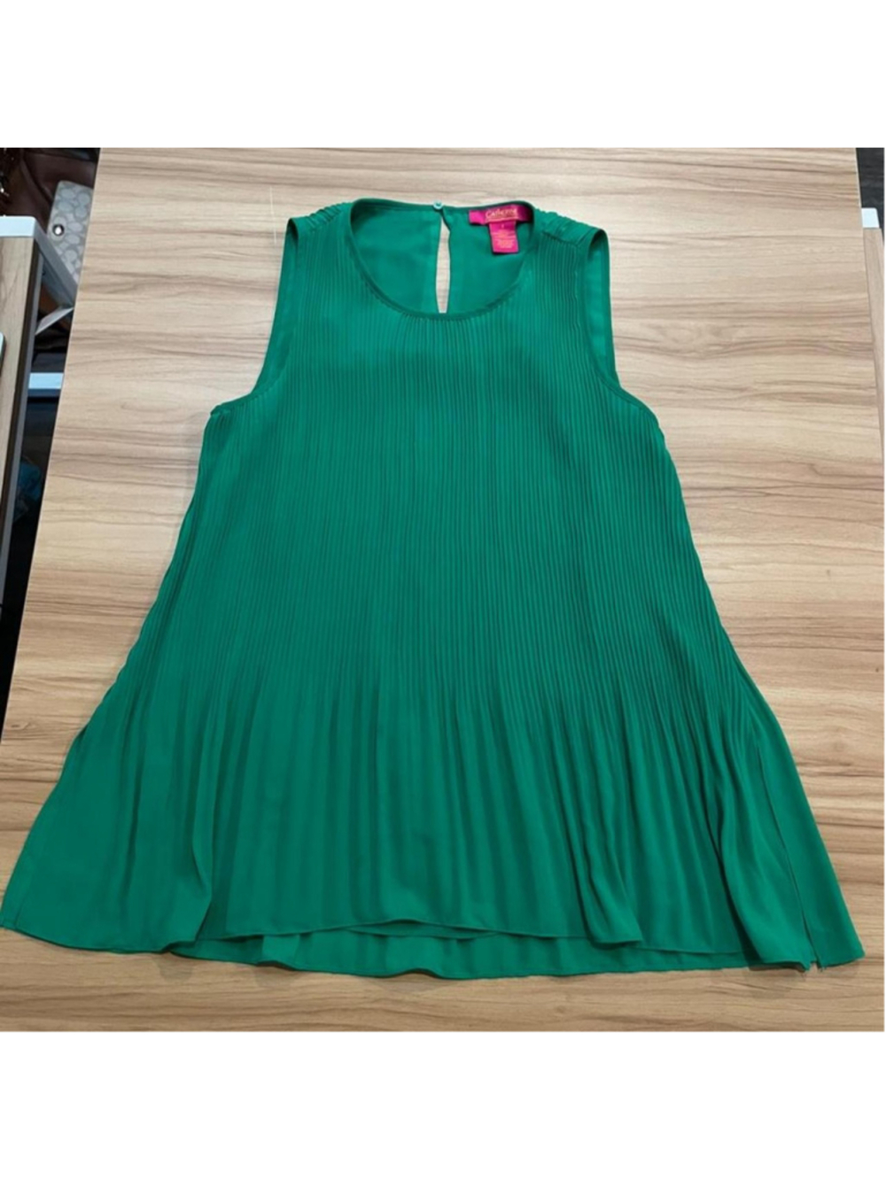 Emerald green Catherine Malandrino pleated swing top with a flowy A-line fit and